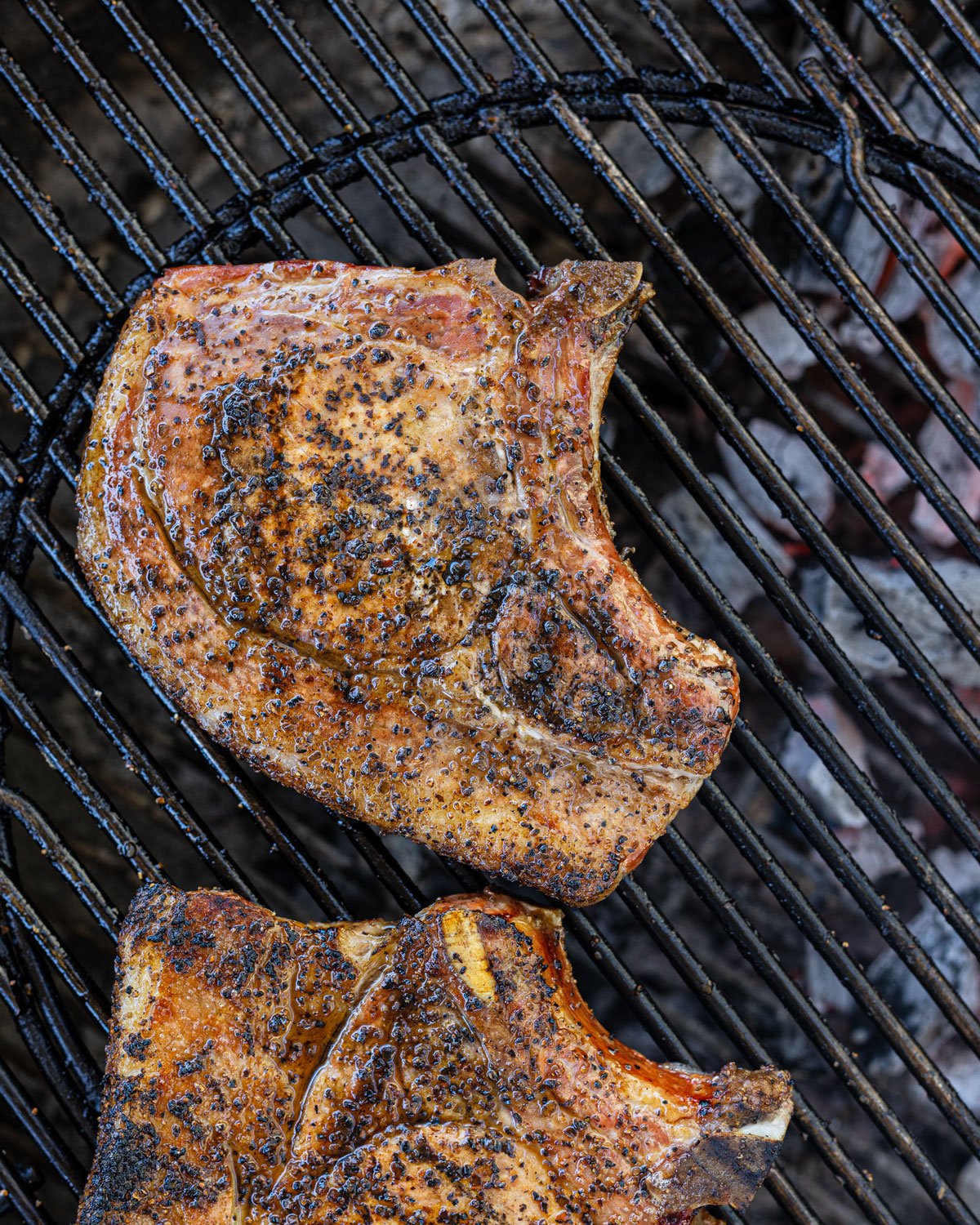 Overhead shot of smoked bone-in pork chops on the grill.