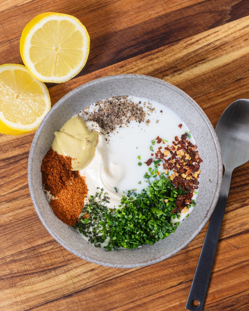 Key ingredients in a bowl with a spoon and lemons