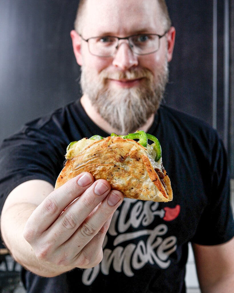 Brad Prose holding a fried smash taco