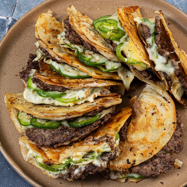 Featured plate of crispy fried smash burger tacos with jalapenos