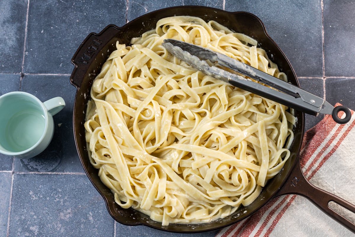 Toss the pasta with the cheese, butter, and pasta water to make an authentic Alfredo sauce