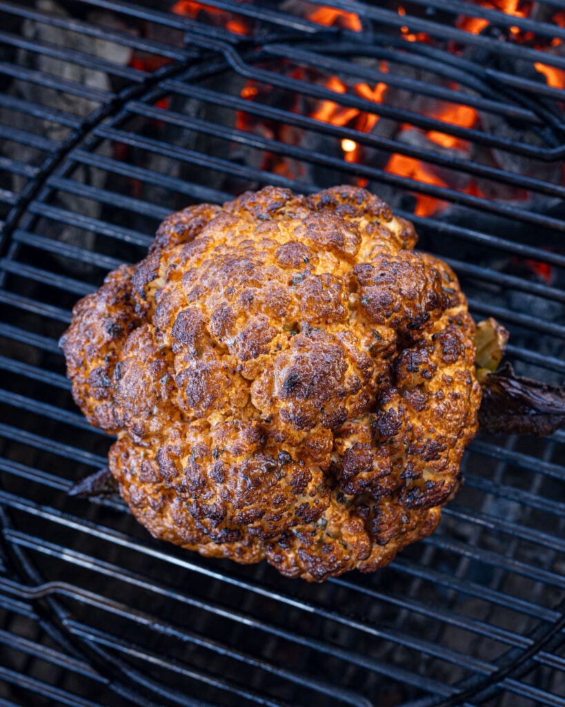 Top view of charred smoked cauliflower on the grill