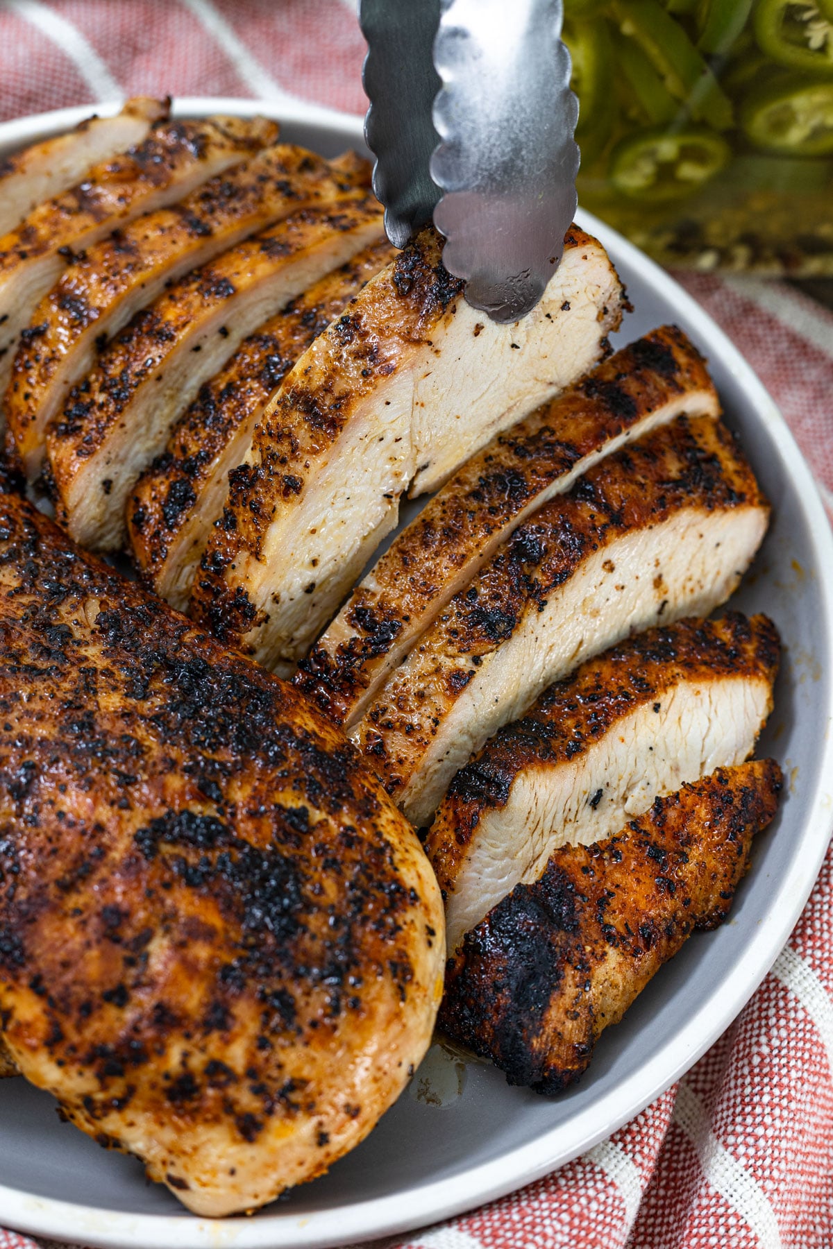Close-up of sliced grilled chicken breast showing the juicy interior and charred seasoned crust