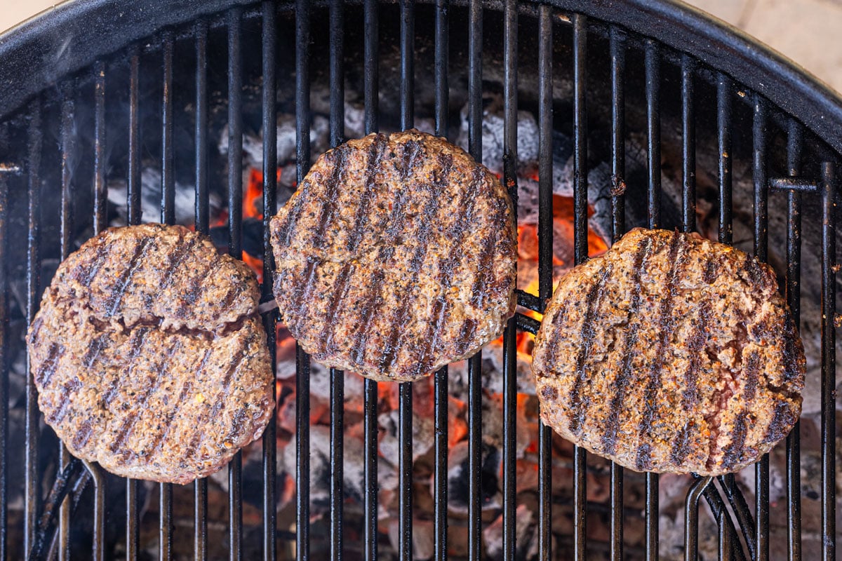 Charcoal-grilled burger patties with dark grill marks