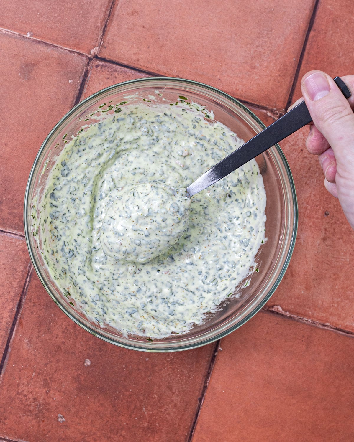 Chimichurri stirred into mayonnaise by hand until evenly green and flecked