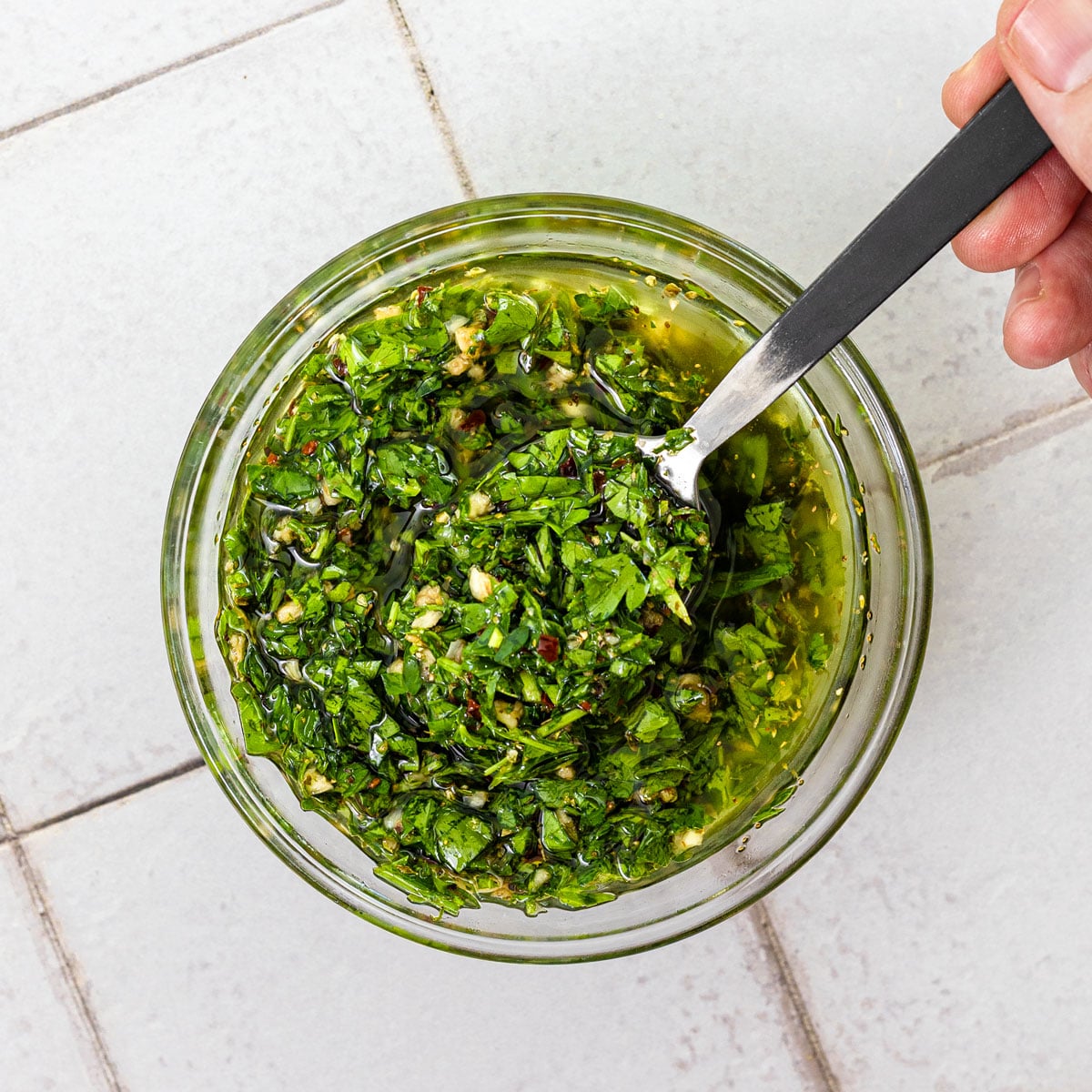 Hand-chopped chimichurri with distinct herbs and a loose, oily texture