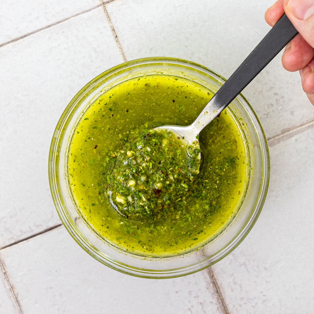Chimichurri run smooth in a food processor, uniform and thick like a dressing