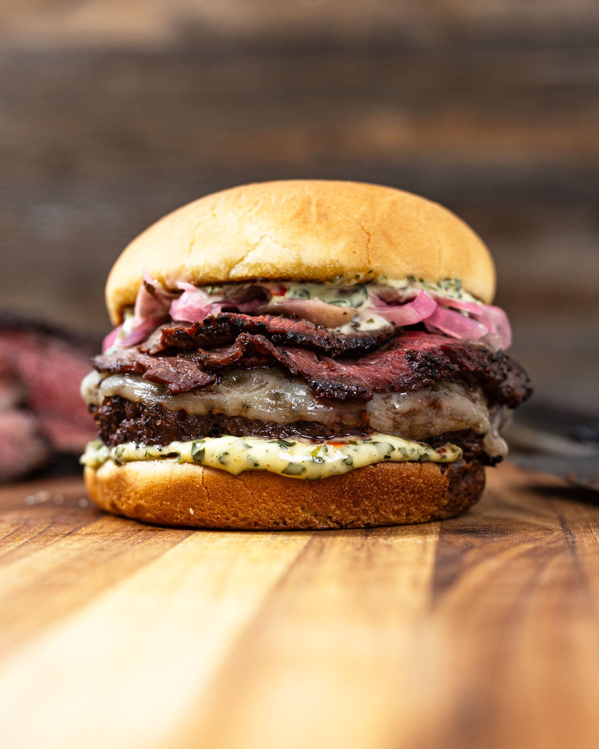 Picanha burger stacked with provolone, pickled red onions, and chimichurri mayo