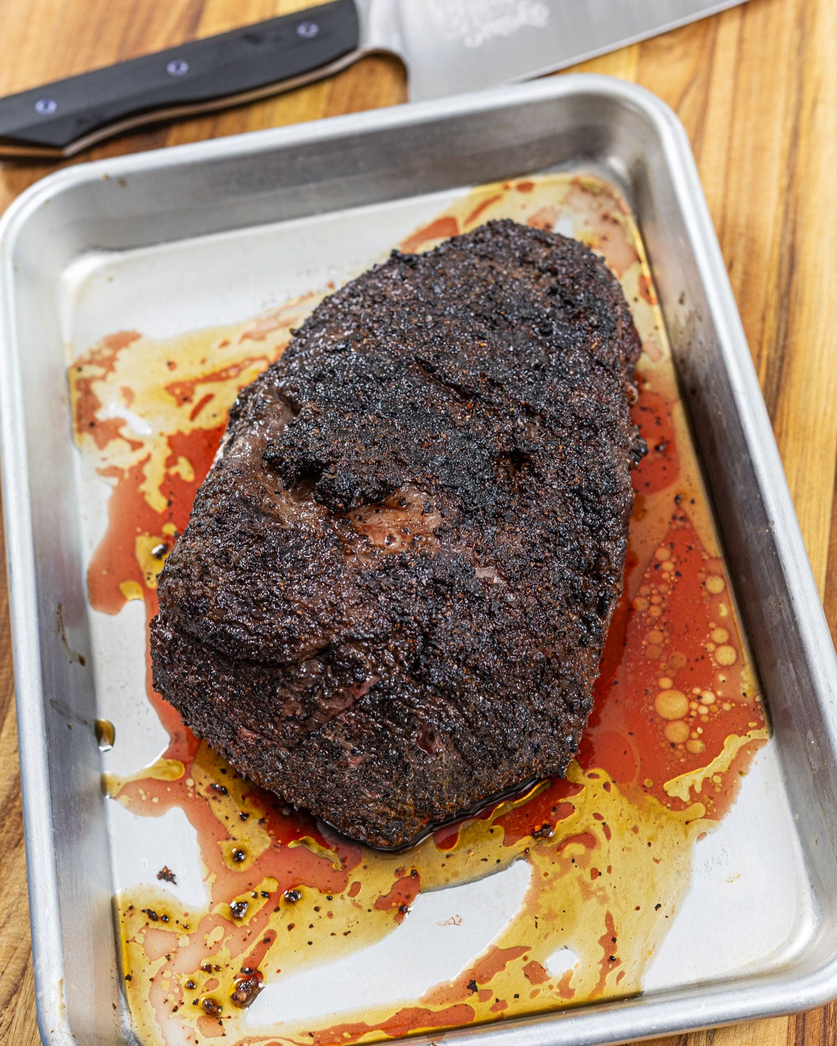 Reverse-seared picanha resting on a tray before slicing